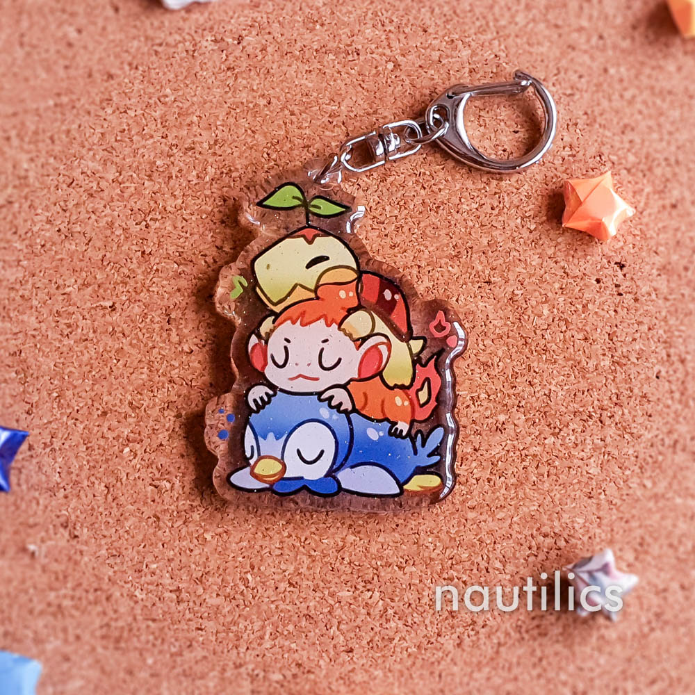 Pokemon Starters Acrylic Charms (B-Grade) by Nautilics Photo of an acrylic charm featuring the Sinnoh Pokemon starters, stacked atop each other in a pile.