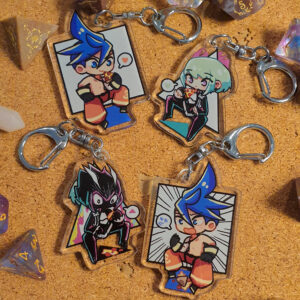 Photo showing the full set of Promare charms featuring both the front and back sides of the Galo and Lio designs.