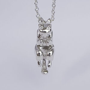 Silver cat charm curled up as if being picked up by the scruff of her neck on a necklace.