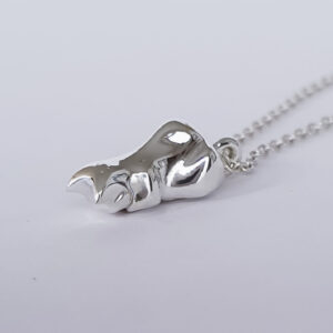 Sterling Silver Cat charm on a chain that is curled up with all paws tucked in and face down.