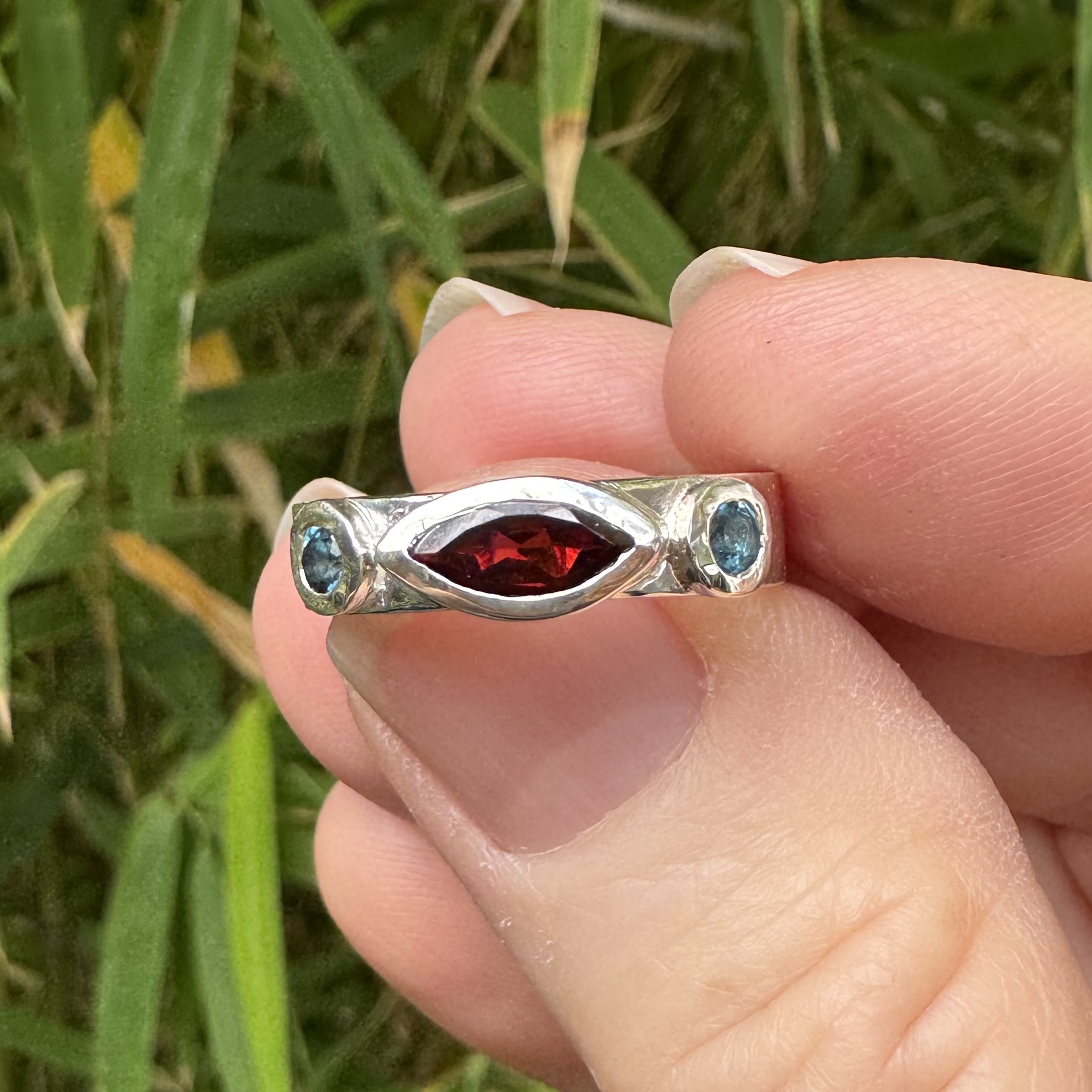 Adora ring | Marquise garnet Size Q by Artefact Fine Jewellery Marquise garnet silver ring with london blue topaz accent stones