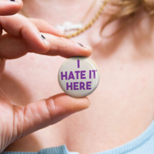 Australian badge saying "I hate it here" by Bordermind Baby – 32mm pin badge handmade in Melbourne