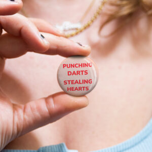 Funny Australian badge saying "Punching Darts Stealing Hearts" by Bordermind Baby – 32mm pin badge handmade in Melbourne