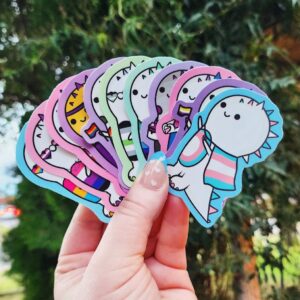 Show your pride with a fun and colorful dinosaur twist! These stickers are 7 cm and printed on high-opacity adhesive vinyl, these stickers are durable, vibrant, and perfect for decorating notebooks, laptops, water bottles, planners, and more.